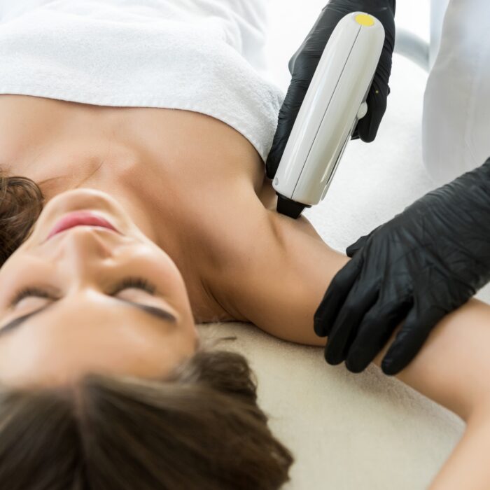 beautiful young woman having laser hair removal on armpits
